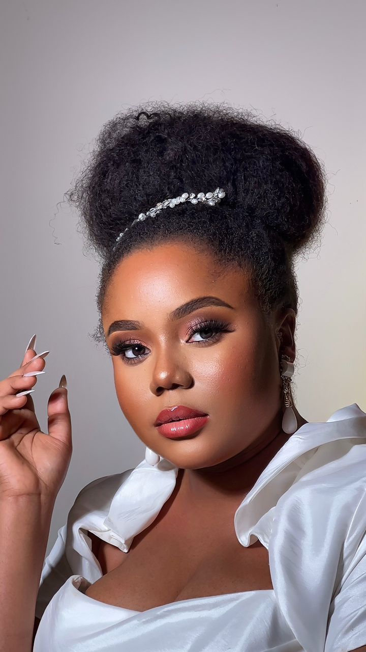 Glam with an afro bun and pearl hairpiece