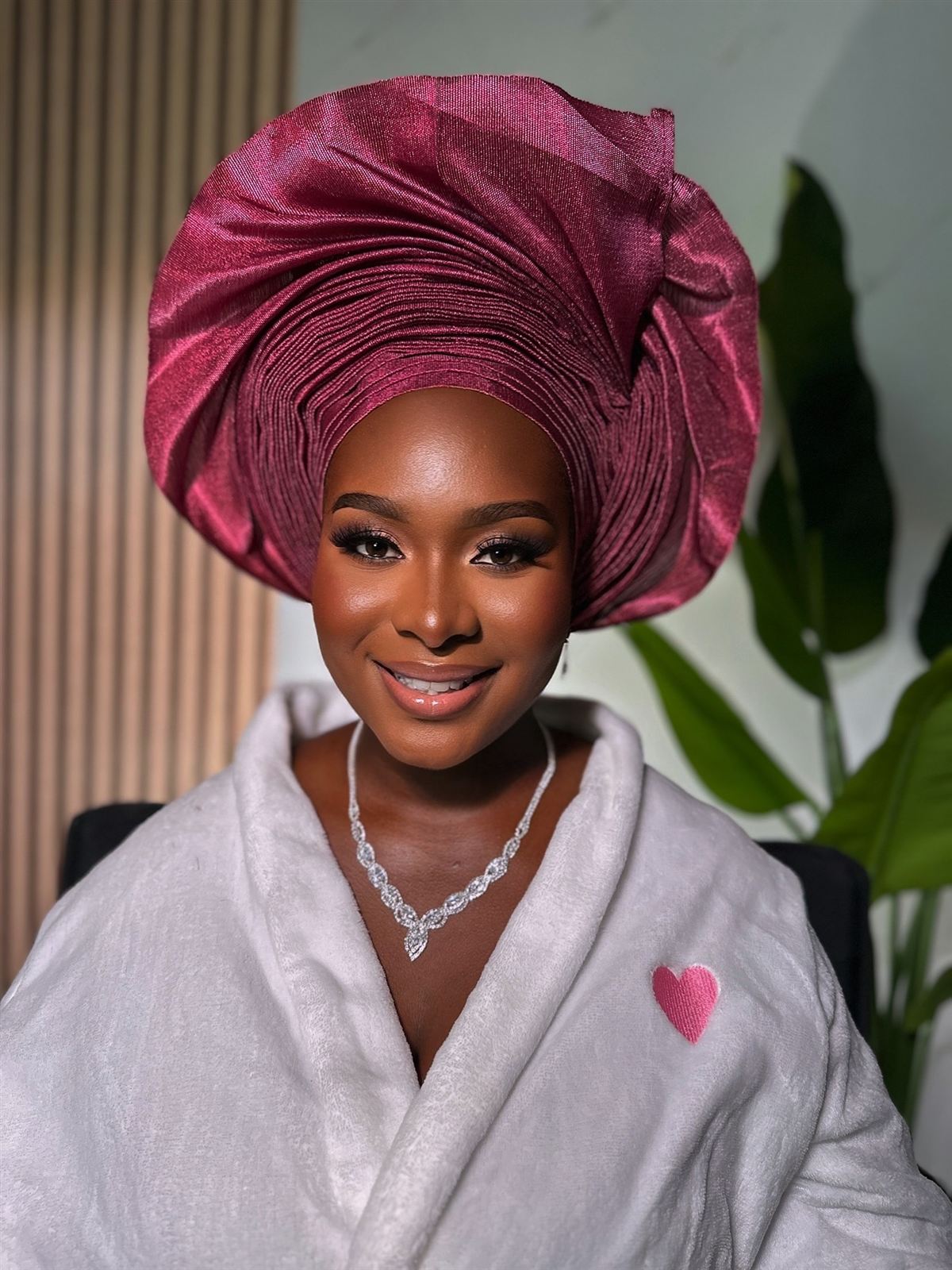 Soft glam with a burgundy gele headwrap