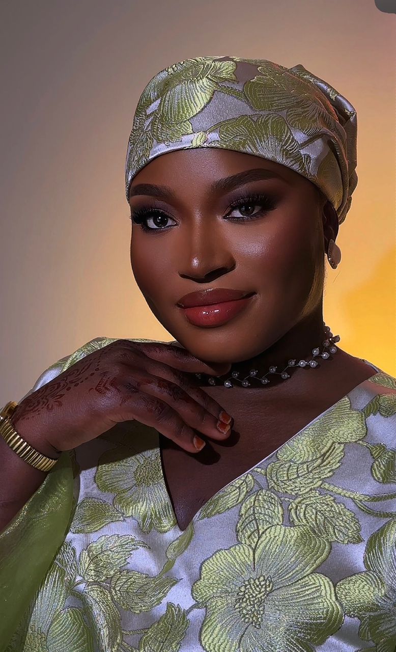 Traditional glam with a green gele and henna